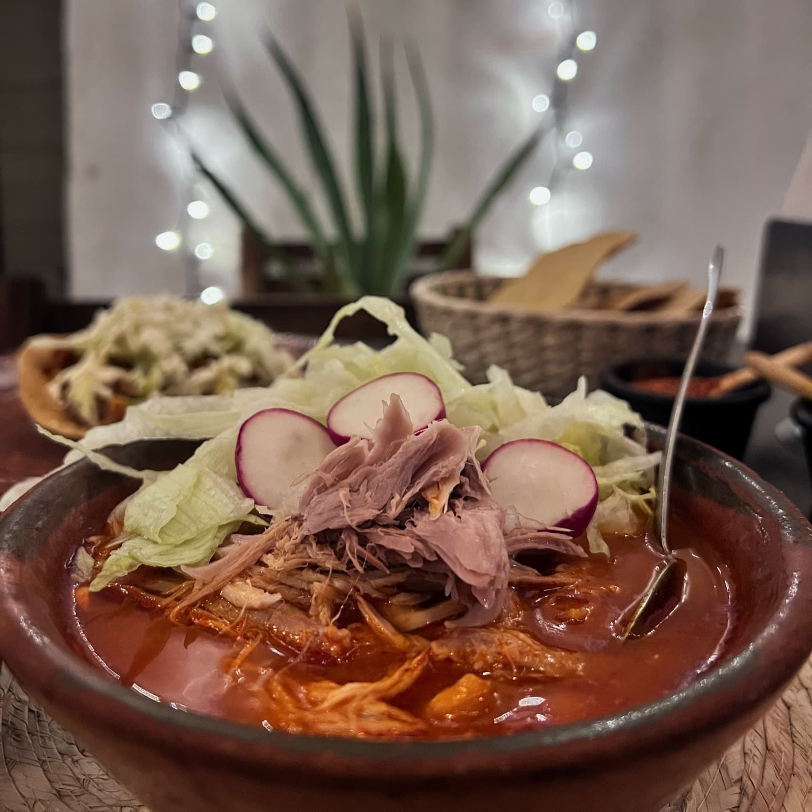 Pozole rojo servido con guarniciones